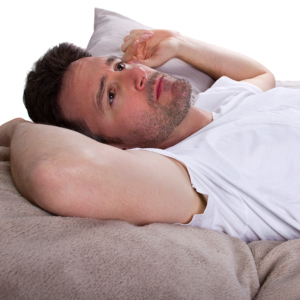 man in bed, looking at ceiling